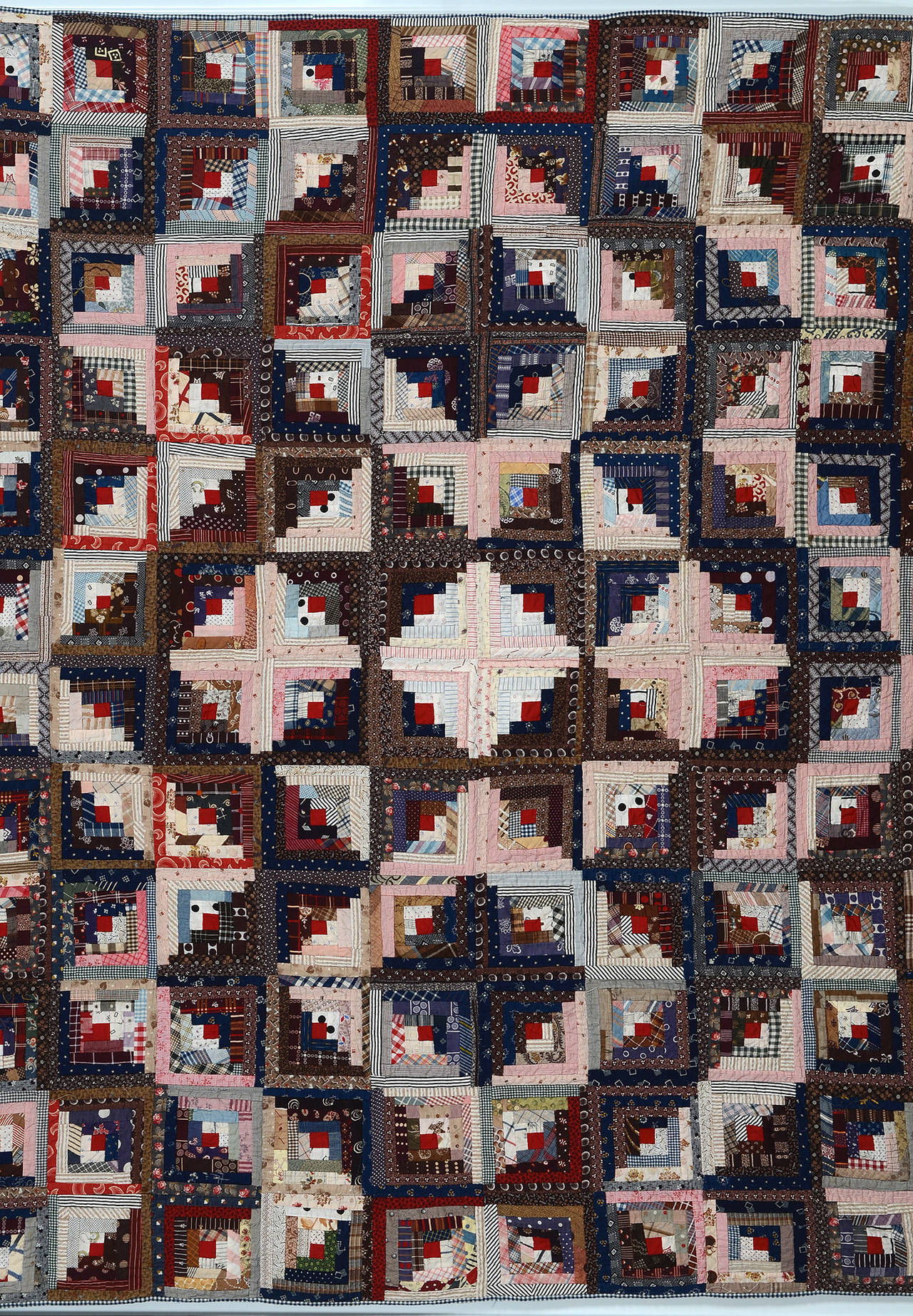 This unusual log cabin quilt is actually three different patterns. There is a streak of lightning surrounding the star center as well as a light and dark pattern above and below the star. It is extraordinary to realize that the same log cabin block
