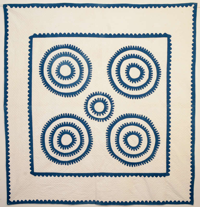 This original quilt pattern brings several things to mind. The circles can be seen as ship's wheels with the curved appliqued borders as gentle ocean waves. Another, less romantic, possibility is machine gears. The viewer might see additional