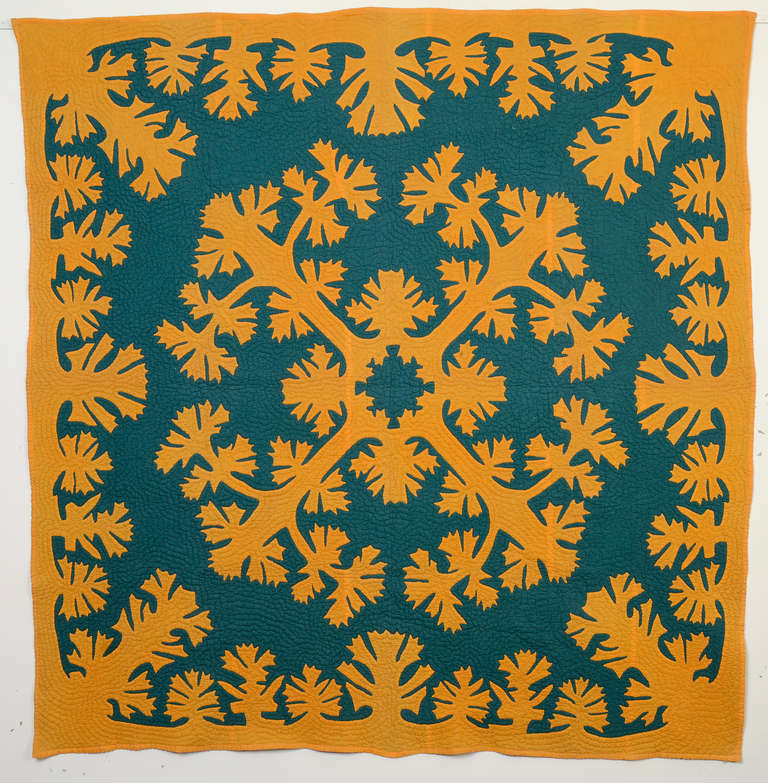 This traditional Hawaiian applique quilt is done with colors more typical of Pennsylvania than Hawaii. I don't think I've seen another Hawaiian quilt with this rich teal background. It is stitched with echo quilting, typical of Hawaiian quilts, that