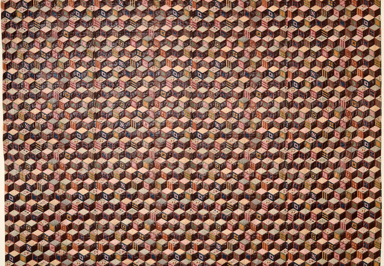 This wholecloth Tumbling Blocks quilt is made of cheater's cloth which is printed patchwork. This example is unusually early; large and beautiful. Two sides of each block are made to look like a printed fabric offset by a solid brown side. The