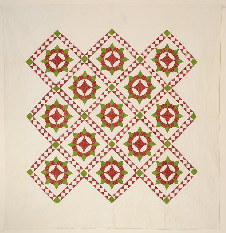 This Caesar's crown quilt has a wonderful diagonal sashing filled with diamonds that adds lots of zing to the piece. It is beautifully quilted with a variety of patterns. The corners are filled with pots of flowers and grape clusters with leaves