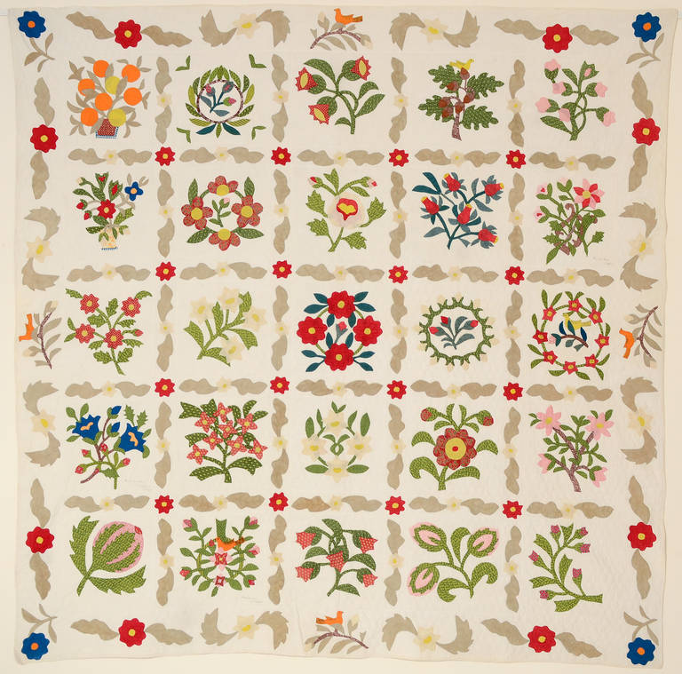 Charming album quilt with floral blocks that include 6 birds with inked details. One of the blocks is signed 