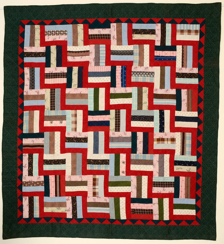This bold version of a Fence Rail Log Cabin quilt  forms an additional pattern of Streak of Lightning with the solid red logs. All well framed by a triangle border. Excellent blending of fabrics. Pristine, unwashed condition. Measures 80