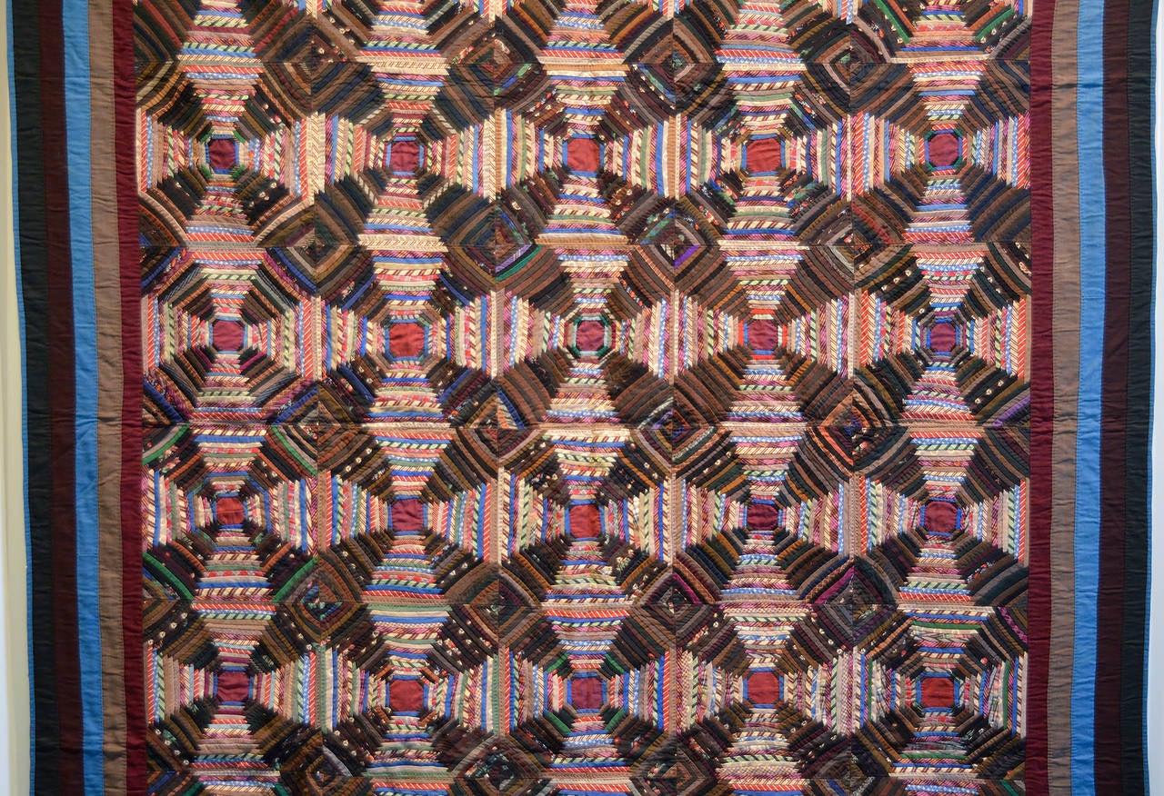 This Mennonite windmill blades log cabin quilt (aka Pineapple Log Cabin) is one of the finest I have had the pleasure to own. It is made of wool challis with deep, rich colors and five borders that repeat fabrics within the quilt. The logs are a
