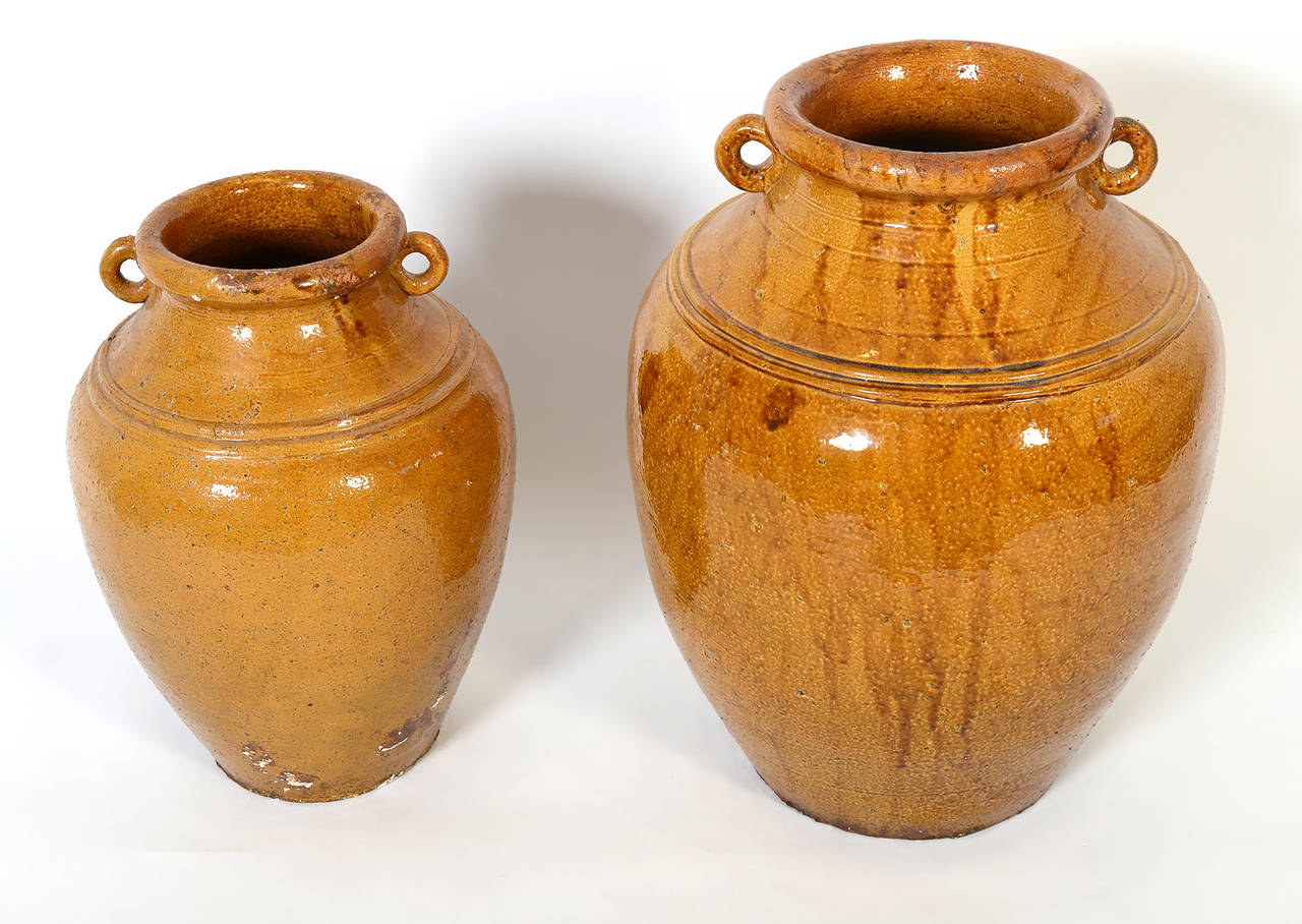 These French terra cotta storage jugs are unusually large. The one on the left is 17 1/2