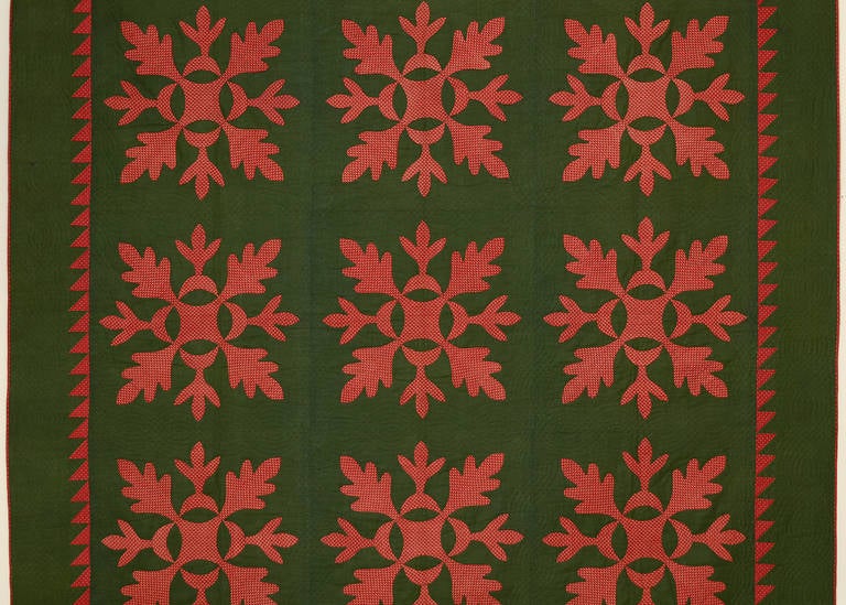 This oak leaf pattern quilt is a fine example of a traditional pattern. It is very well quilted with cable patterns throughout. The oak leaves may appear to be rust or brick color but they are actually red. The deep green background may make the