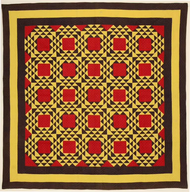 The use of solid colors make this Ocean Waves quilt especially strong. It is beautifully planned with red triangles inside the triple borders making an additional frame. The dark color is an unusual one. It is somewhere between charcoal gray and