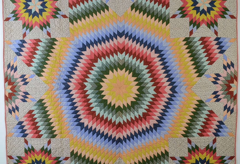 Vibrant and exciting Star of Bethlehem Quilt (aka Texas Star) from Montgomery County, Pennsylvania. Full and half stars around the central one make for a very full, rich composition. 
The backing is a beautiful paisley print to which the quilt can