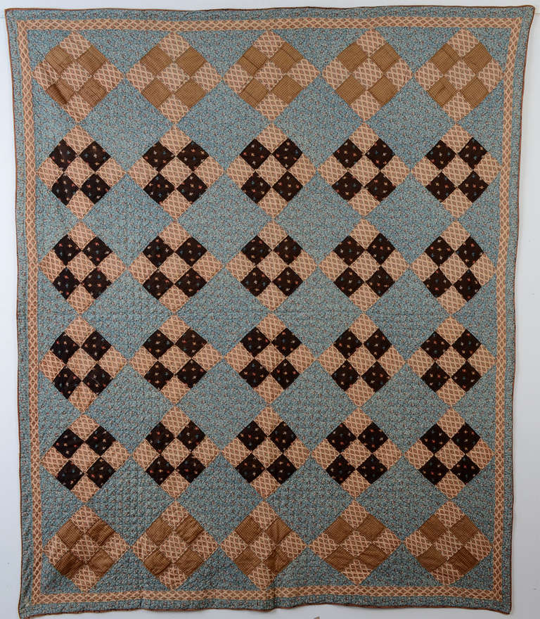 Nine Patch Quilt made of fine, printed wool challis fabrics on both front and back. It has a wonderfully rich color palette. Measurements are 72