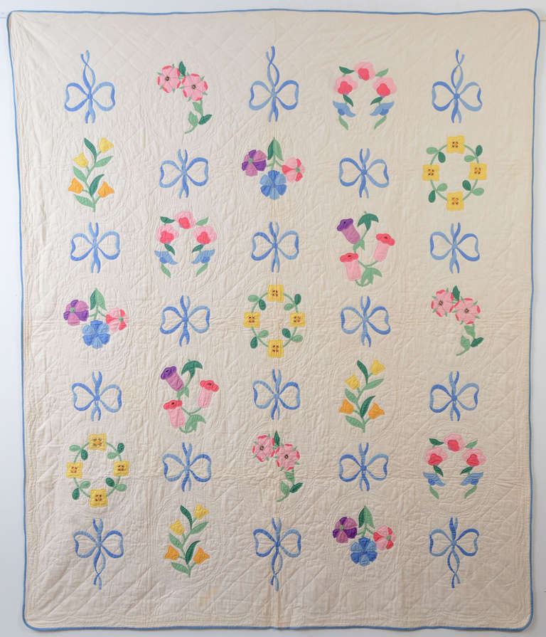 Light and airy applique quilt of floral wreaths and bows. It is surely a kit quilt but not one I have seen. Quilted with ovals around the groups of flowers. Measures 78