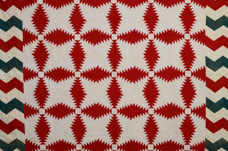 The combination of the Windmill Blades (aka Pineapple Log Cabin) quilt pattern with a Streak of Lightning border makes for a real eye dazzler. The use of solid color, rather than patterned fabrics, adds to the impact. Opposing corners are treated
