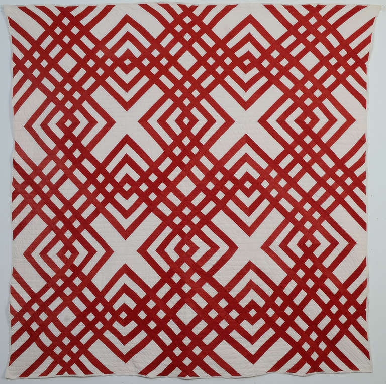 Carpenter's Square is the totally appropriate name for such an architectural quilt pattern. The use of solid red and white makes this version especially dramatic. Quilted in patterns of straight lines.Ohio origin; circa 1880. Freshly laundered and