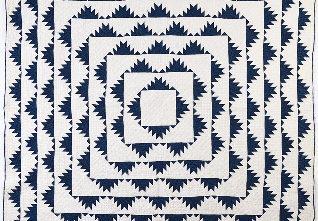 This dynamic Delectable Mountains Quilt is done in the most popular color combination of indigo and white. It is well quilted with two geometric patterns. The quilt has been professionally laundered and is in excellent condition. It was made in