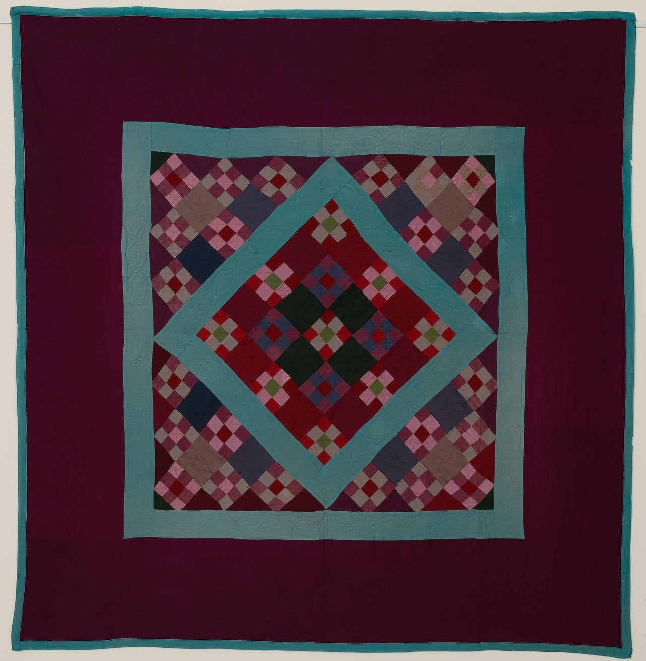 This Lancaster County Amish nine-patch diamond in a square quilt has it all. The four very dark green squares in the center diamond and the nine patches around them create an additional subtle diamond within the central one. Rarely, rarely does one