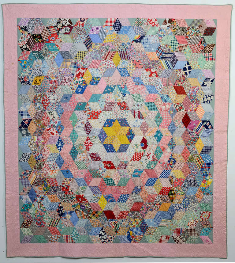 This amazing quilt makes two great patterns and all done as a charm quilt, meaning no fabric is repeated! The overall hexagon pattern is made up of concentric rows of tumbling blocks. The quilt is made of a virtual library of 1930's fabrics, many of