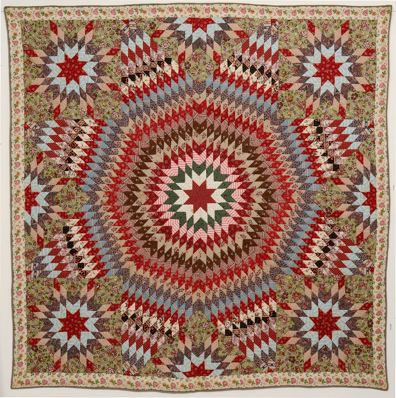 The bold use of both pattern and fabric make this starburst quilt a real eye dazzler. The maker clearly was not afraid of combining patterned fabrics and she did it beautifully. Where possible, she took particular care to center the diamonds with