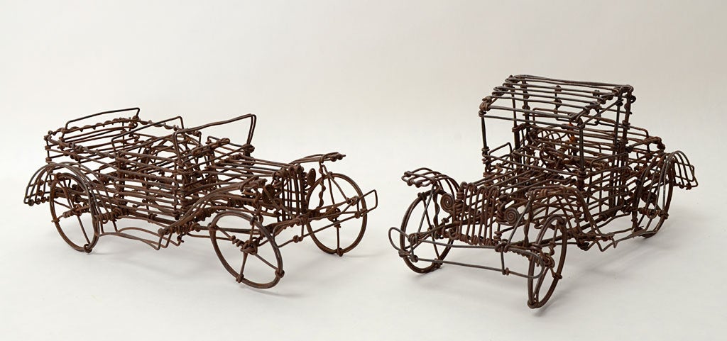 These two wire sculptures of early automobiles were made by the same hand as the bicycles listed in item U120310916064. As with the bicycles, there are stylistic similarities but differences in the models. Both have doors that open. Whimsical