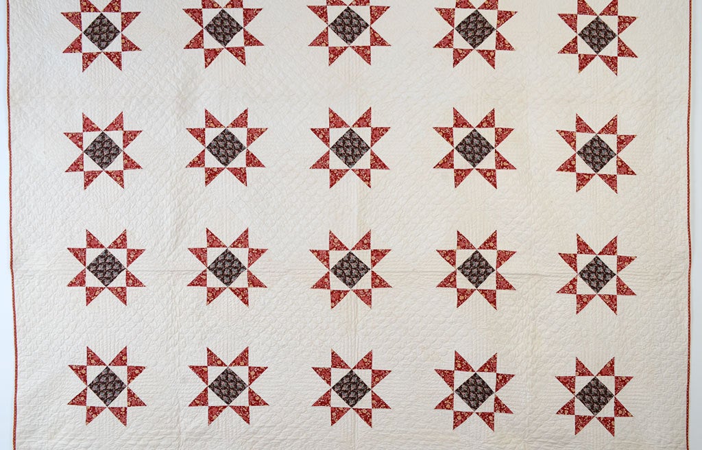 This is a finely quilted Variable Stars pattern from the 1850's. It is in excellent, professionally laundered condition. White blocks are quilted with clamshell designs. It measures 86