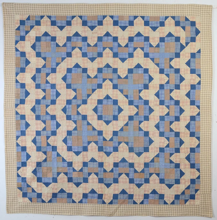 This type of center medallion quilt made entirely of small squares and triangles is typical of the Perkiomen Valley of Pennsylvania. The color palette of this example is most out of character for its type. It is made of turn of the century shirting