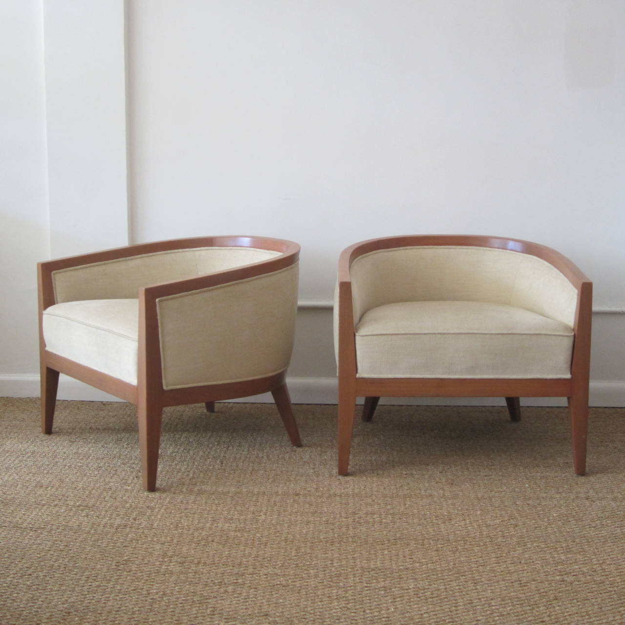 Pair of curved wood frame armchairs newly upholstered with matching small lumbar cushions included, not shown. Wood is finished. Sold as a pair.