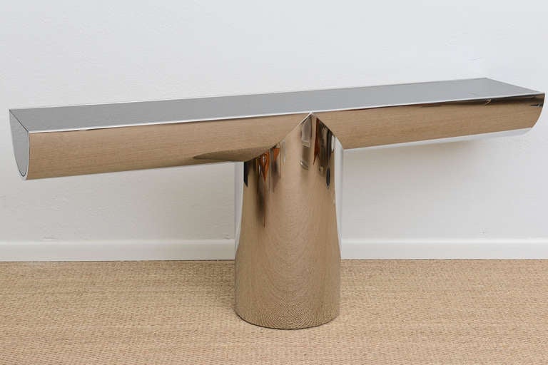Stunning cantilevered console table fashioned of polished steel with black glass top and sides.