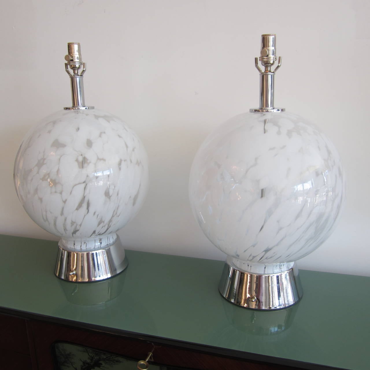 Pair of Vistosi handblown Murano glass sphere lamps with chrome bases and appointments. Rewired.