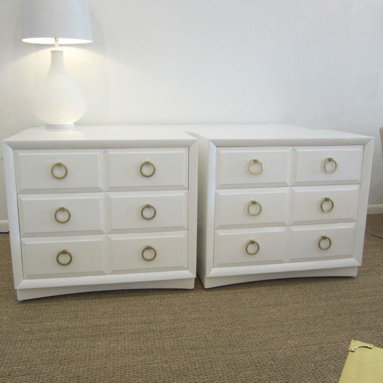 Gorgeous pair of chests featuring three drawers each with beveled edges including center bevel providing the illusion of two drawers side by side. The crescent shaped bases hide the original casters for easy maneuvering while the bodies have been