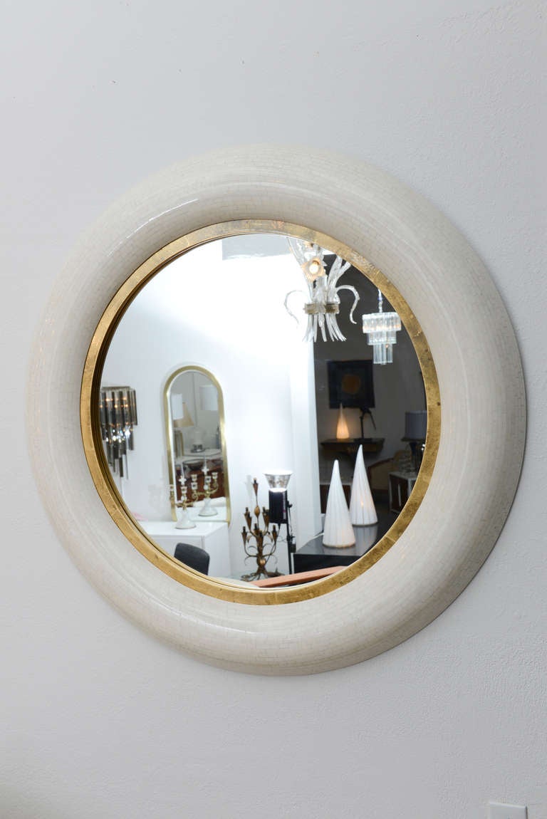 Beautiful round mirror made wholly of inlaid bone tiles. The band running the circumference of the mirror is gold leaf and accentuates the mirror perfectly. The round frame is also convex offering an almost feel.