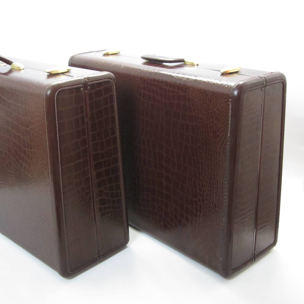 Two leather suitcases in embossed-crocodile leather with brass appointments. Super clean interior and barley used--no scent. Great for chic travels, storage display in bedroom/living room, props, etc. Sold as a pair.