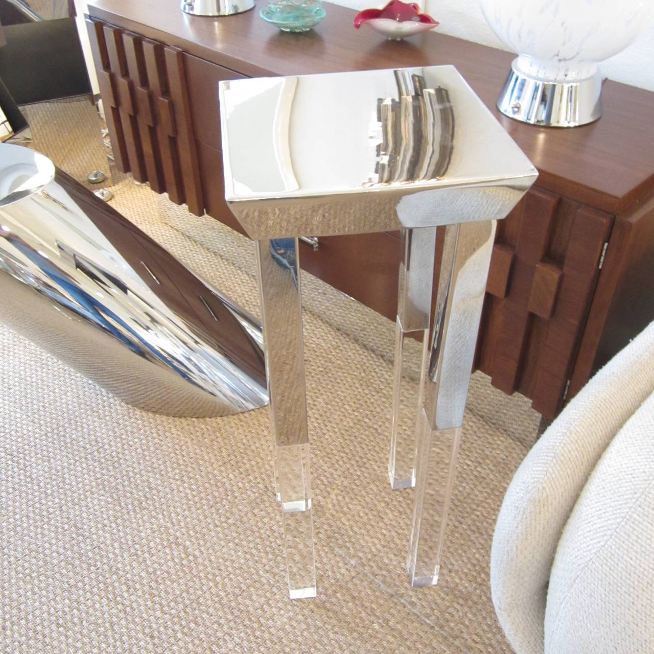 Gorgeous polished steel-top and partial leg side table with the balance of the legs in extended Lucite block. The sides of the top surface are inverted creating this fantastic look. Great as a lamp or sculpture table.
