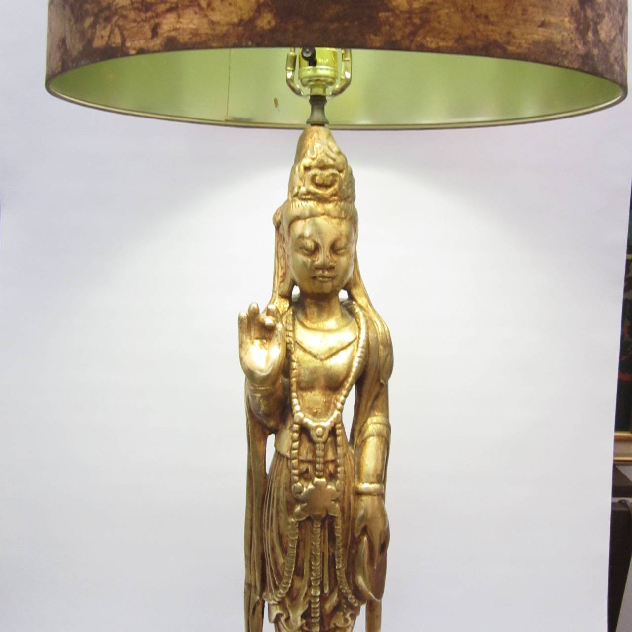 Gilded wood figural lamp with hand gilded and painted shade. 
Height to top of socket: 36 in.