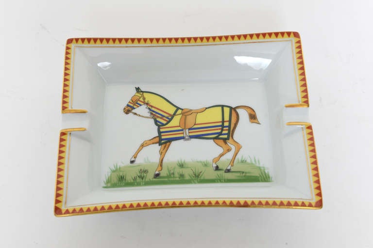 Porcelain ashtray/ dish with pyramid boarder and depicting horse with Hermes riding gear. Signed Hermes--Paris.