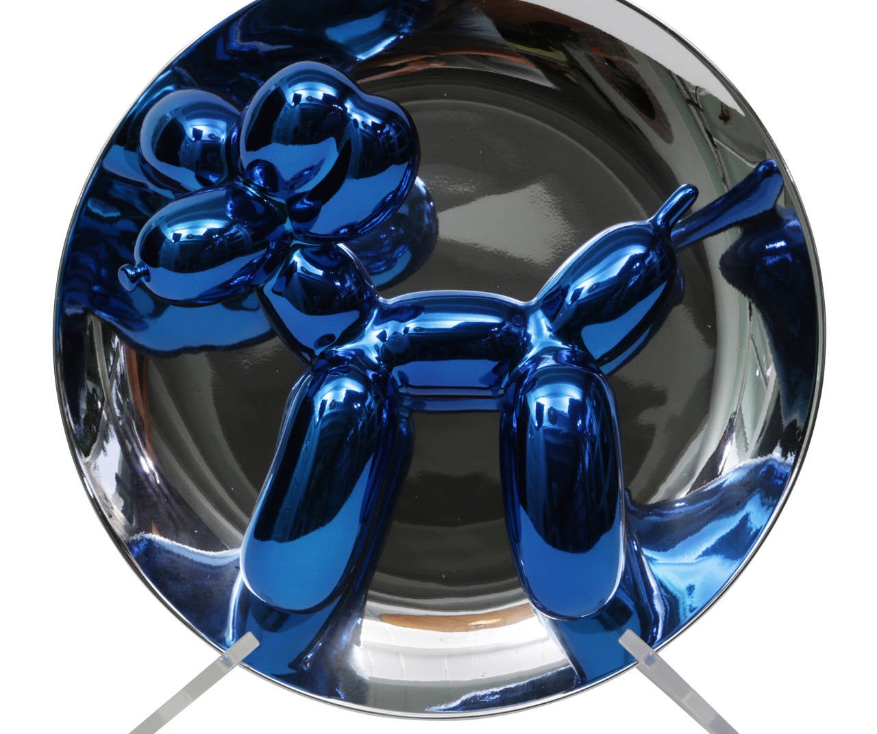 Jeff Koons created this limited edition dog sculpture in fine porcelain with a metallic glaze. Presented on its original plastic stand, the sculpture is labeled and numbered on the reverse side of the dish, plate number 1319/2300. All original