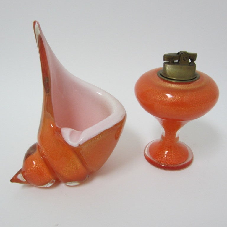 Fantastic mouth blown Venetian crimson glass turbo shell ashtray and standing mushroom table lighter with original brass insert mechanism. Sold as a pair. Great for collectors, these smoke sets are documented and will probably never be made