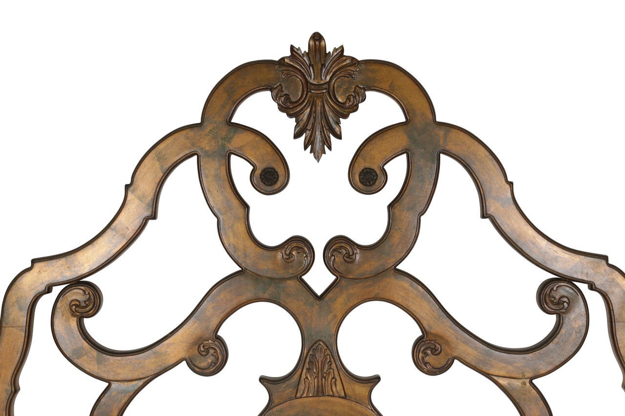 Early Venetian inspired, this giltwood queen size bed has a lot of integrated design elements including the bas relief flour-de-lis, the incised arabesque bullseyes and the inverted flu-de-lis top center.