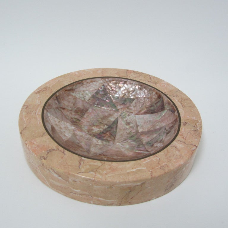 Elegant round tessellated pink marble dish with tessellated mother-of-pearl center. Thin brass band separates pearl from marble. Lovely tabletop display and catch-all.