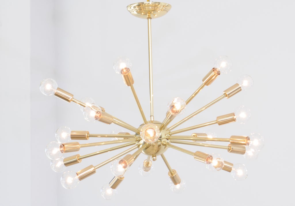 Stunning high polished brass sputnik chandelier featuring 20 arms. It measures 23 inches high to the ceiling cap by 31 inches in diameter. Polished, restored, rewired, and ready to be hung.