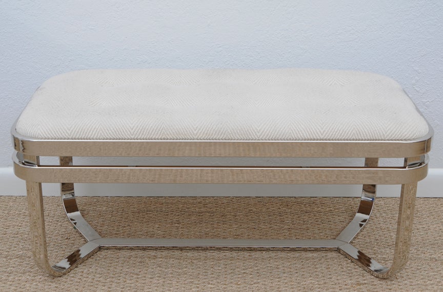 Beautifully constructed bench with four curved banded legs meeting at a central bottom cross bar. An additional band directly below top compliments while adding to the structure. Thick heavy bands are solid brass with nickel plating. Cushion is