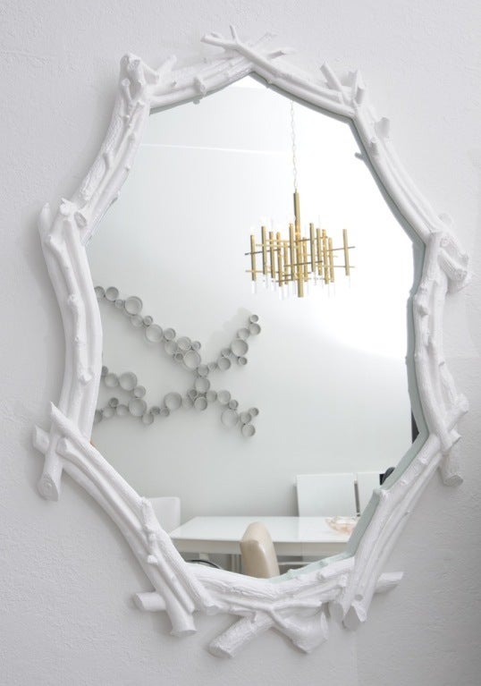 Beautiful faux bois twig mirror finished in white lacquer. Excellent display of craftsmanship visible in this solid, heavy, and well executed mirror. 
Signs of ware on the frame which contribute to the beauty of this mirror without compromising the