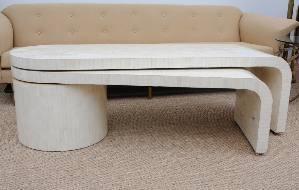 Two tiers of bone inlay over wood that pivot from the center bone clad drum. Each sliding table surface has wheels and glides effortlessly to swing open or closed. The drum is stationary. Each tier has a waterfall edge creating a soft flow of