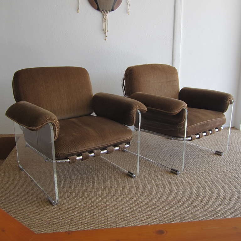 Fabulous pair of lounge or club chairs named the Argenta chair when they were produced in the late 1960's and early 1970's by  The Pace Collection. The side panels are lucite and have chrome cylindrical base bumpers while the framing is tubular
