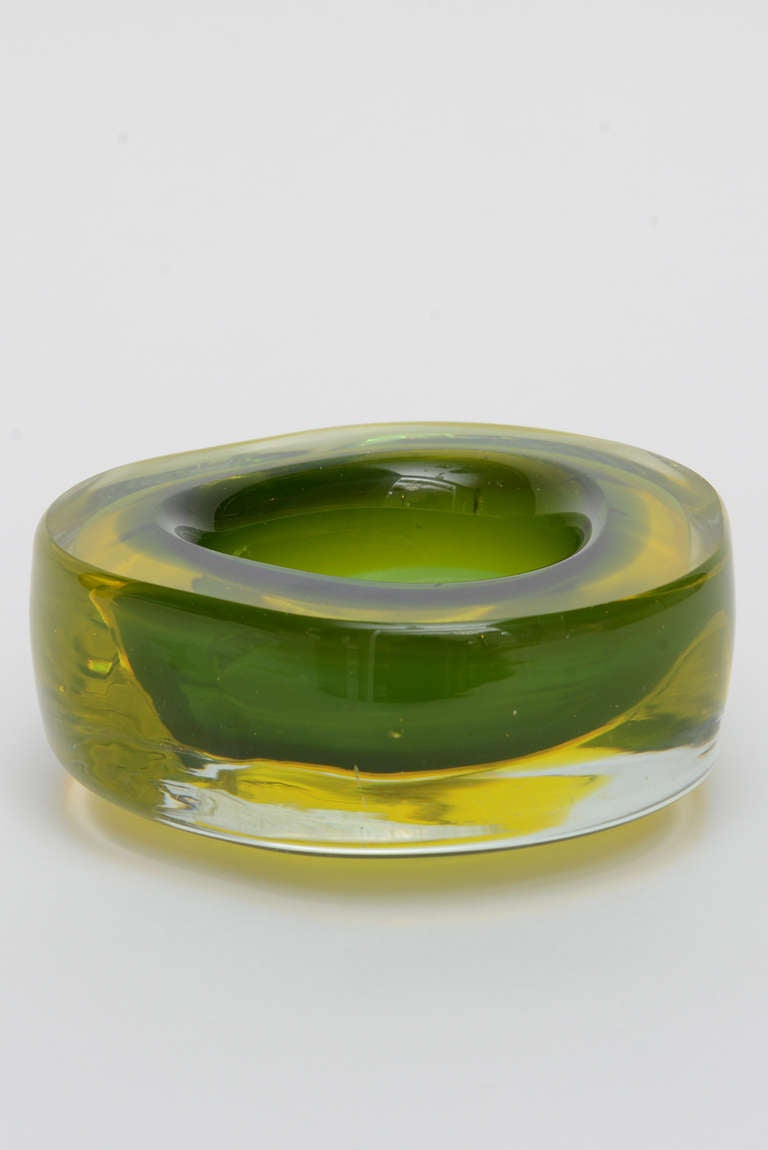 Hand blown Murano glass dish in green and hues of yellow vaseline. This dish is thick and has an almost round shape--very attractive. There is one tiny flea bite that the camera could not detect.

NOTE: PLEASE FEEL FREE TO CONTACT OUR GALLERIES