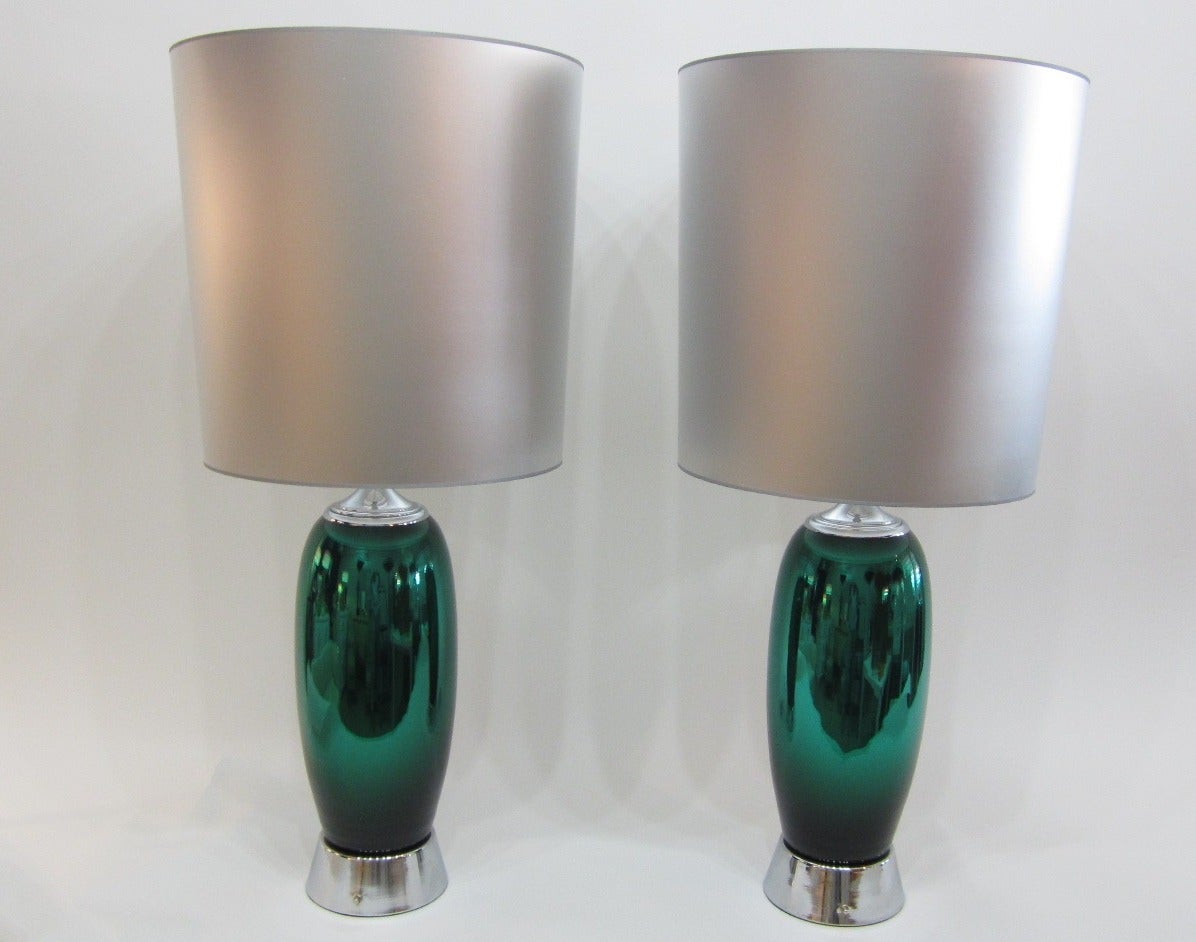 Fantastic and tall pair of monumental green mercury-glass lamps newly rewired with nickel bases and fittings. Sold with or without the inverted silver shades. Statement lamps, will work great with many decor styles! 