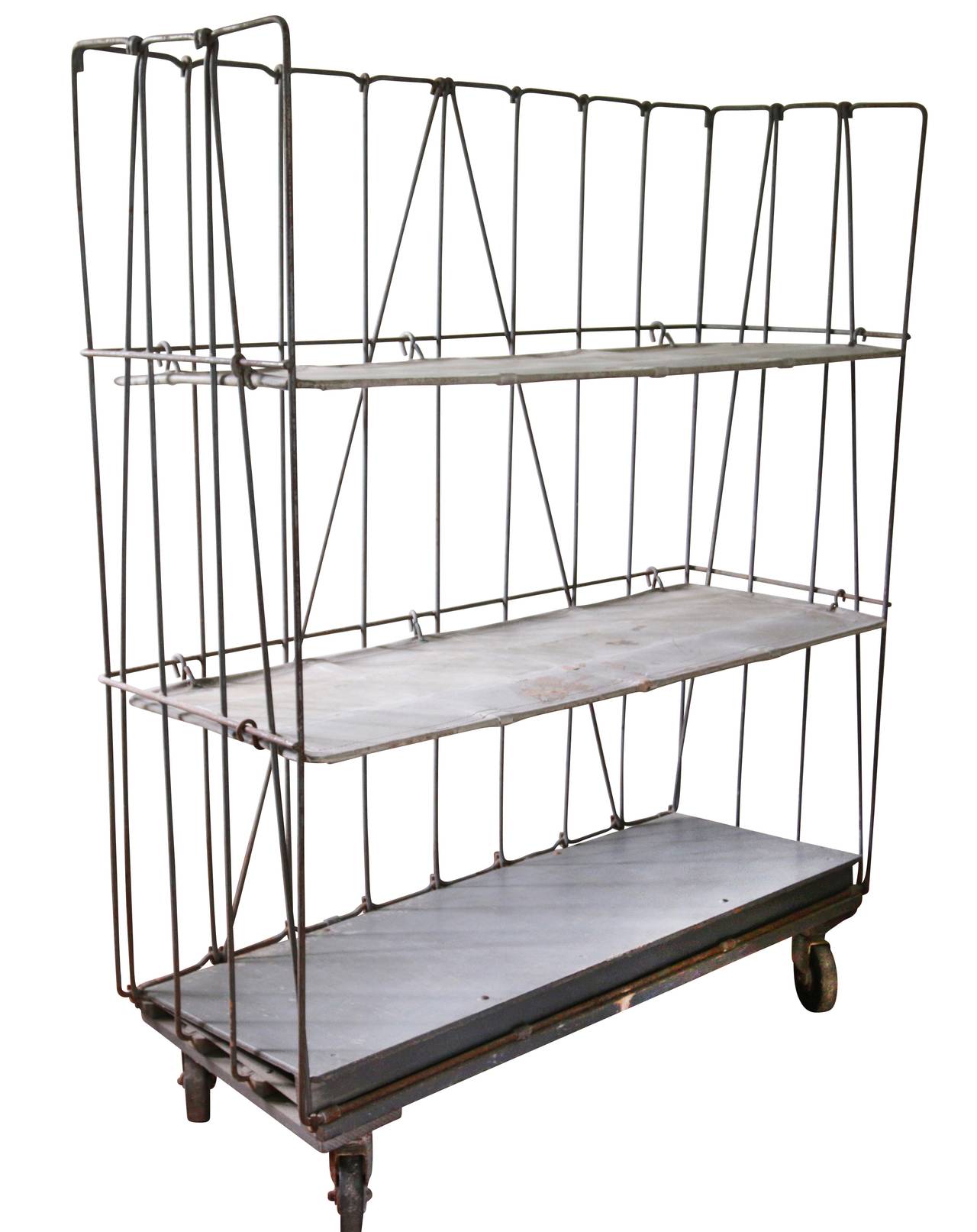 Soho garment factory rolling cart engineered to hold hundreds of pounds. Surprisingly lightweight on four wheels. Steel structure with steel-lined coated-canvas shelves. One of the few remaining artifacts from that time and place.