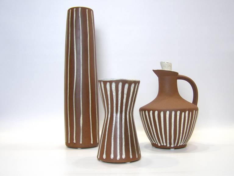 Three-piece collection of signed Roche Pottery consisting of tall vase, smaller 