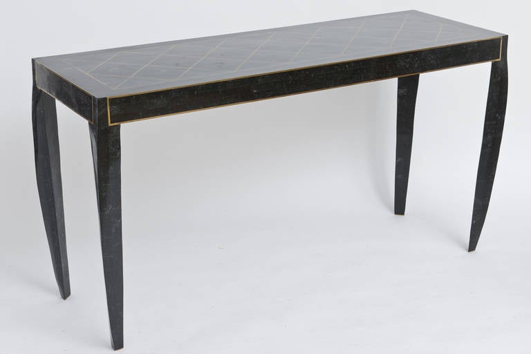 Fantastic inlaid tessellated marble console table with solid brass banding inlay creating the X patter on top surface. The sides are also framed in the solid brass banding. The legs are hand carved after the console is put together which