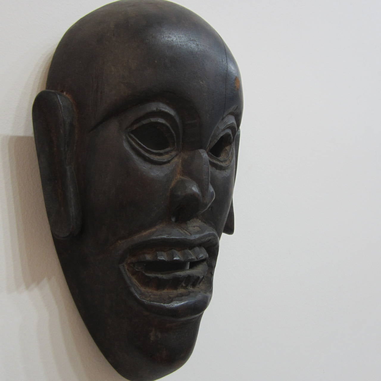 Hand-carved wood mask from West Africa from mid-20th century.
