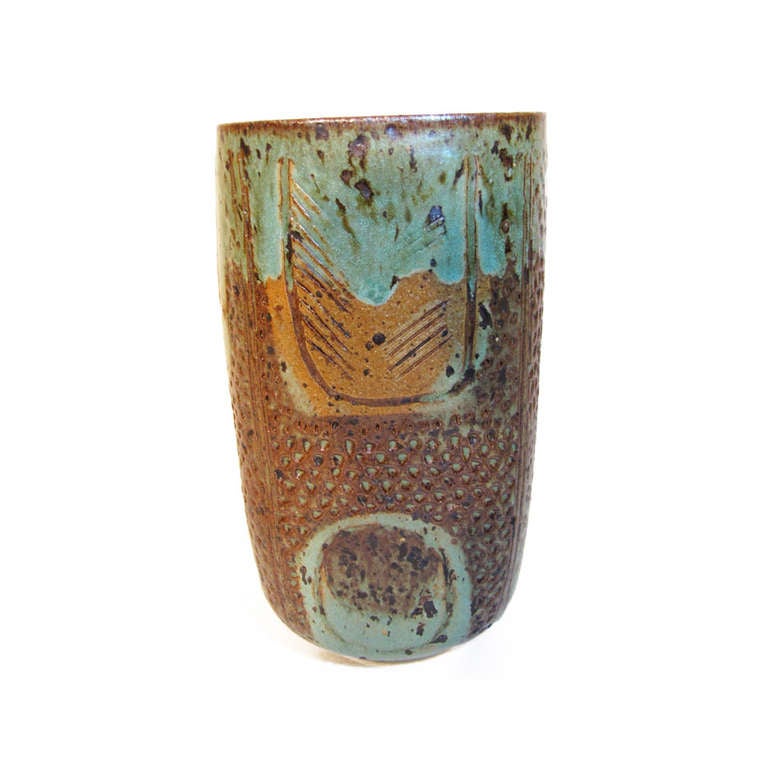 Vintage studio pottery vase by Marguerite Wildenhain featuring Manganese infused clay with heavily decorated surfaces and thick creamy green glaze.  Classic textural style and sgraffito are evident in this squared vase form.

Measures 7.75