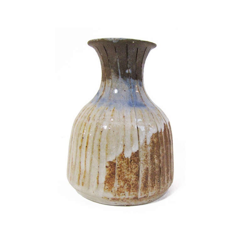 Diminutive studio pottery vase by Marguerite Wildenhain thrown white at pond farm.  Signature creamy glaze with dripping blues and vertical incised surface.

Measures 4.25