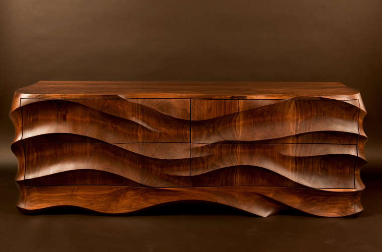 Hand carved solid walnut low / media chest by Caleb Woodard featuring exquisitely detailed flowing surfaces that highlight the natural properties of the wood.  Deep, quiet close hand dovetailed drawers allow for ample storage.  Due to their